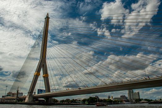 Bangkok, thailand 21 Jul, 2019 : Rama Rama VIII bridge, Rope Bridge across the Chao Phraya River, A tall V-shape pylon tower with view blue sky is background and Cityscape of Bangkok.