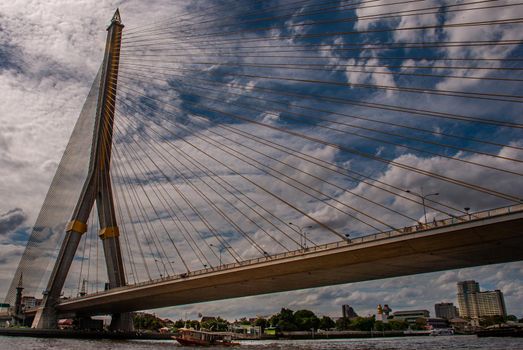 Bangkok, thailand 21 Jul, 2019 : Rama Rama VIII bridge, Rope Bridge across the Chao Phraya River, A tall V-shape pylon tower with view blue sky is background and Cityscape of Bangkok.