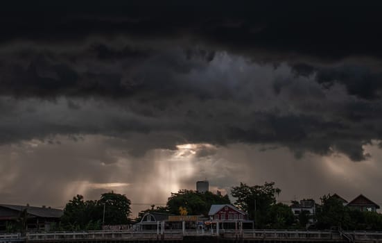 Bangkok, Thailand - 21 Jul 2019 : The restaurant on the Chao Phraya River in the evening with the light passing through the sky shines down beautifully.