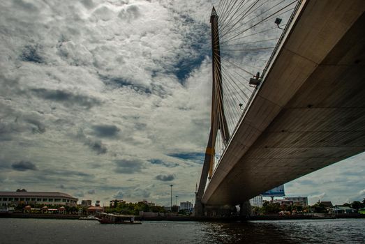 Bangkok, thailand 21 Jul, 2019 : Rama VIII bridge, Rope Bridge across the Chao Phraya River, A tall V-shape pylon tower with view blue sky is background, Cloudy day.