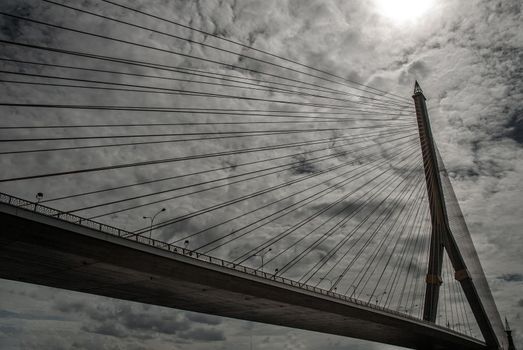 Bangkok, thailand 21 Jul, 2019 : Rama VIII bridge, Rope Bridge across the Chao Phraya River, A tall V-shape pylon tower with view blue sky is background, Cloudy day.