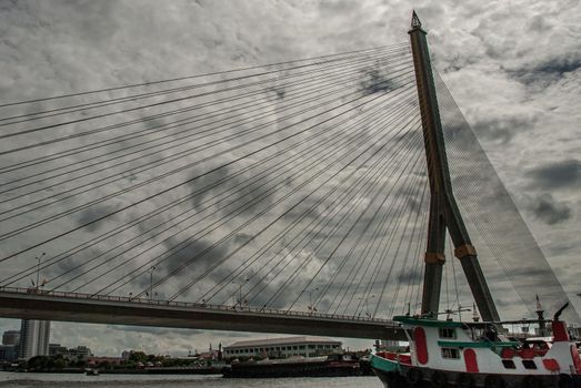 Bangkok, thailand 21 Jul, 2019 : Rama VIII bridge, Rope Bridge across the Chao Phraya River, A tall V-shape pylon tower with view blue sky is background, Cloudy day.