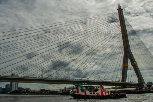 Bangkok, thailand 21 Jul, 2019 : Rama VIII bridge, Rope Bridge across the Chao Phraya River, A tall V-shape pylon tower with view blue sky is background, Cloudy day.