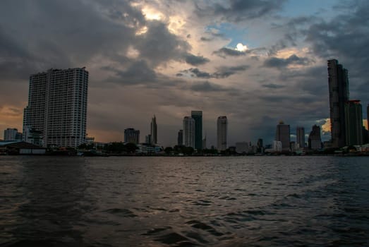 Bangkok, Thailand - 21 Jul 2019: Skyscrapers along the Chao Phraya River in the evening Making Bangkok a beautiful city.