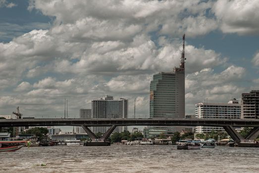 Bangkok, Thailand - 21 Jul 2019 : Somdet Phra Chao Taksin Maharaj Bridge (Sathorn Bridge) is a bridge across the Chao Phraya River with a backdrop of tall buildings and beautiful skies.