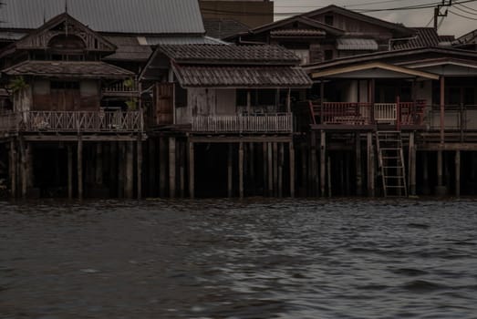 Bangkok, Thailand - 21 Jul 2019 : Beautiful views from old wooden local houses  in the evening along the Chao Phraya riverside.