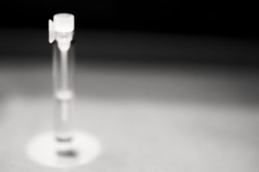 Glass bottle with perfume sample. No people. Copy space