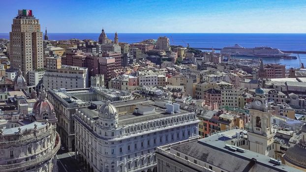 Aerial panoramic drone view of buildings and streets surrounding Port of Genoa.Important hub of maritime trade and tourist art.Old famous city of Italy,with beautiful architecture,houses,roofs.