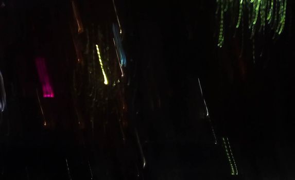 Reflection in a glass of glass. Blurred fires of distant houses. Window.