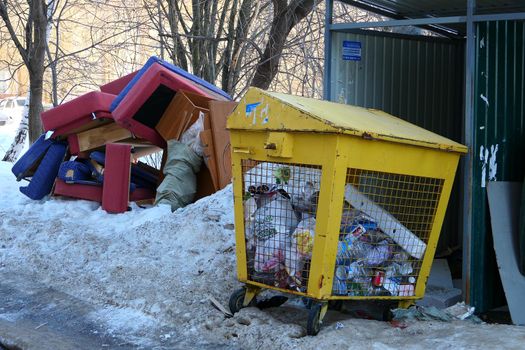 Old furniture thrown in the trash near the street trash cans. High quality photo.103 Gagarin Avenue, Nizhny Novgorod, Russia, 29.03.2021