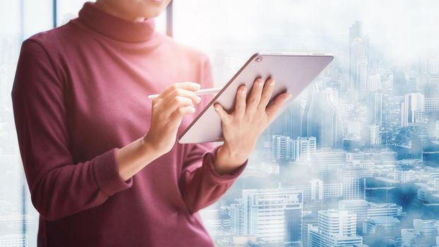 Modern business woman in the office with city background and copy-space