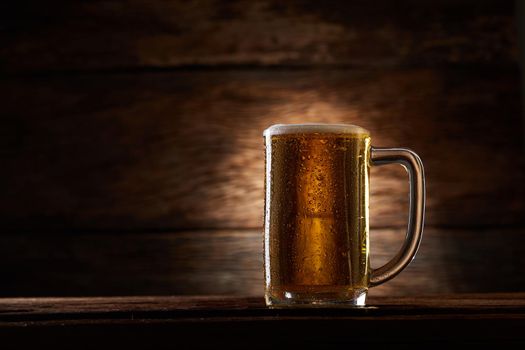 Glass beer on wood background with copy space