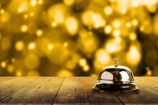 Bell of service on wooden with golden bokeh background