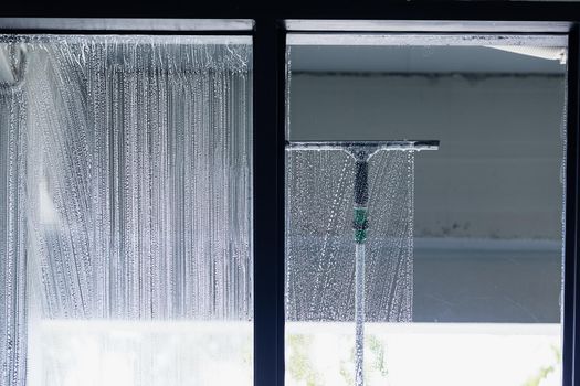 Cleaning window pane with glass cleaner. Cleaning glass concept