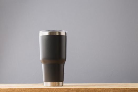 Black Cold Cup or Steel mug on wood table