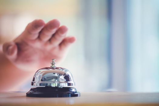 Bell on counter for service with hand. Ring the bell