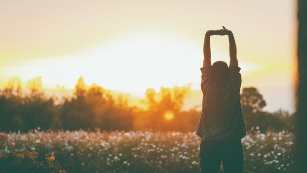 cheering woman open arms at sunrise flowers garden,Nature of Life