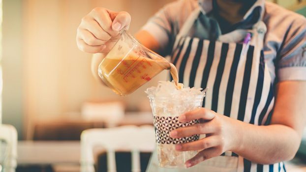 Barista making ice coffee on hand, cold ice coffee