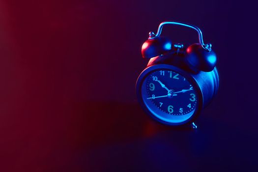 Alarm Clock colorful lighting. Take photo on studio