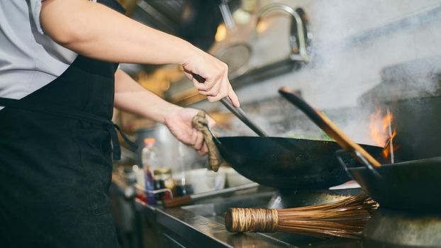 Chef stir fry busy cooking in kitchen 