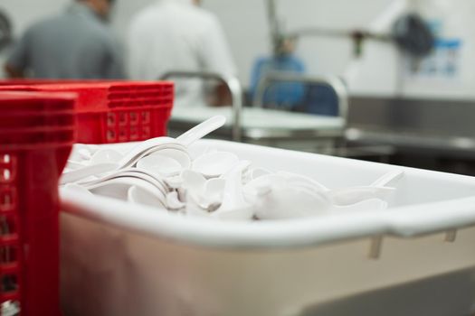 Man washing dish on sink at restaurant