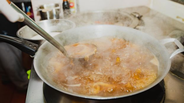 Boiling shark's fin soup. Traditional luxury menu of Chinese