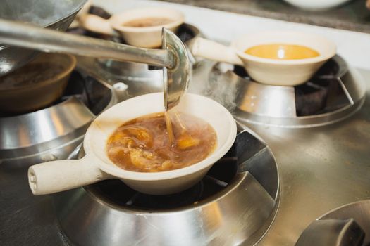 Boiling shark's fin soup. Traditional luxury menu of Chinese