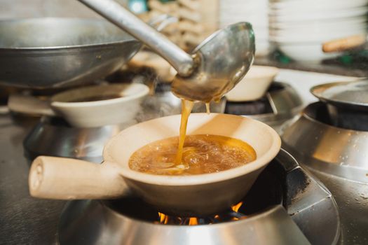 Boiling shark's fin soup. Traditional luxury menu of Chinese