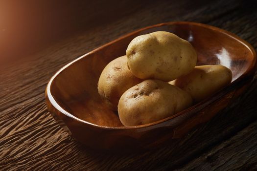 Still life with potato on wood bold