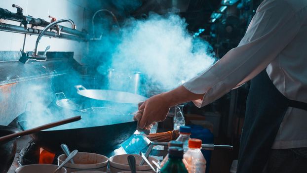 Chef stir fry busy cooking in kitchen