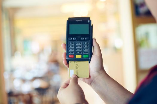 Credit card machine for pay on blurred background