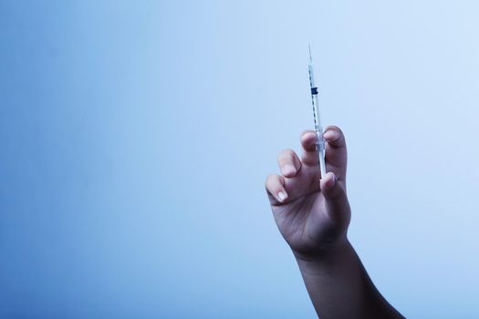 Syringe in the hand for treatment of disease