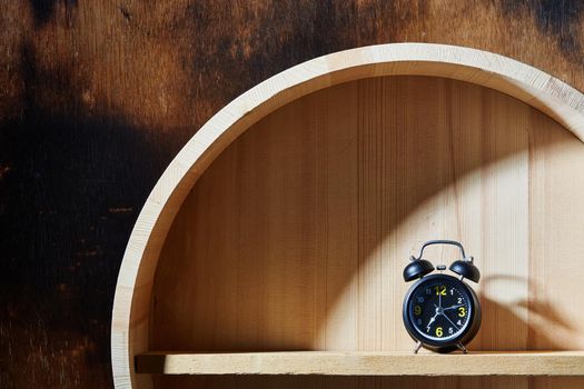 Still life with alarm clock. Alarm Clock with hardlight on wood. Minimalism photo