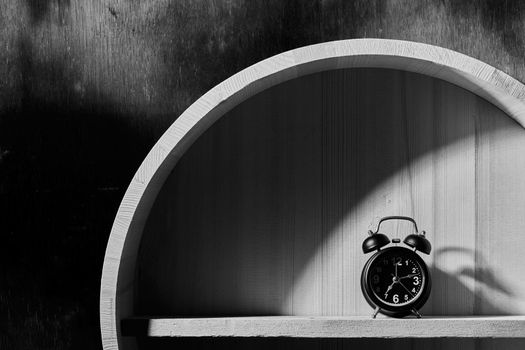 Still life with alarm clock on wood