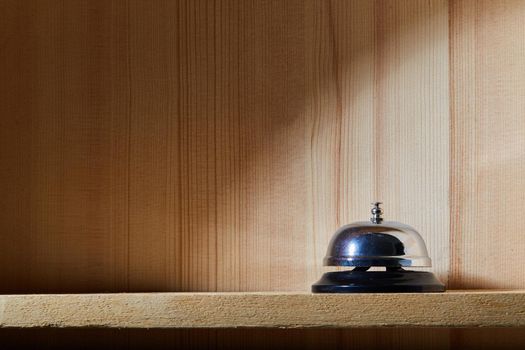Bell on counter for service with wooden background