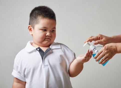 Asia Boy holding bottle with antiseptic cleaning gel. Prevent the virus and bacterias