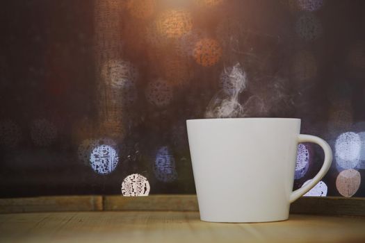 Cup of coffee on wood with bokeh background