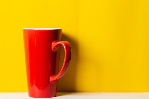 Red cup on yellow background
