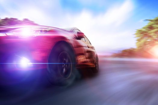 Tires is spin of speeding car with copy space. Low angle side view of car driving fast on motion blur