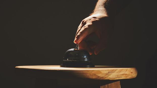 Bell on counter for service with hand  background