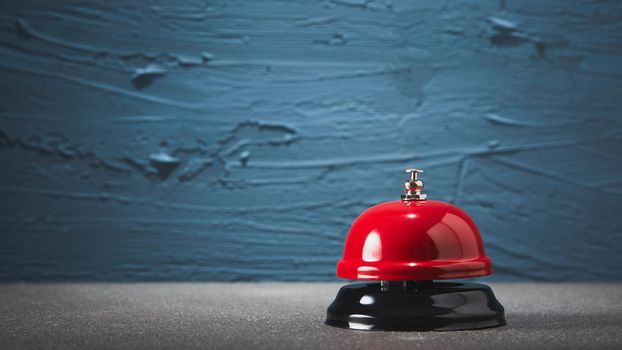 Bell on counter for service with blue rough background