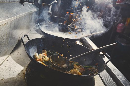 Chef stir fry cooking in kitchen