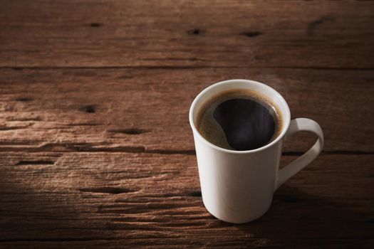 Coffee cup is hot drink on wooden with sunlight