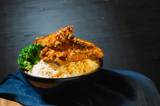 Still life with Baked Pork Ribs Rice on dark background