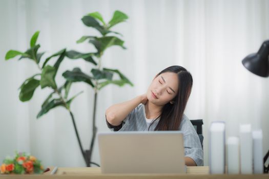 Women work at home until being very tired. Asian women work at home during the Covid-19 epidemic.