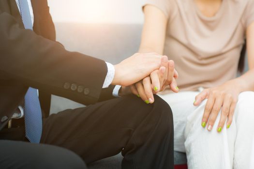 Professional psychiatrist hands together holding palm of her patient