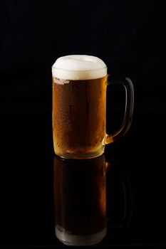 Beeris cold in mug on dark  background