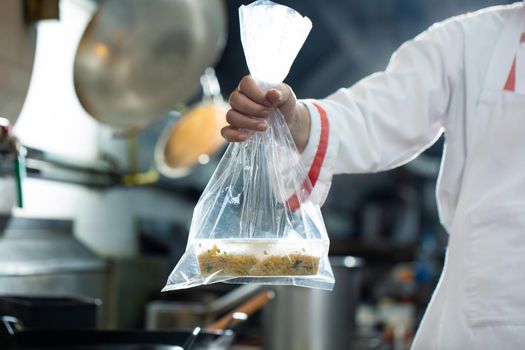 Chef holding food bag for delivery, Food delivery is a new normal