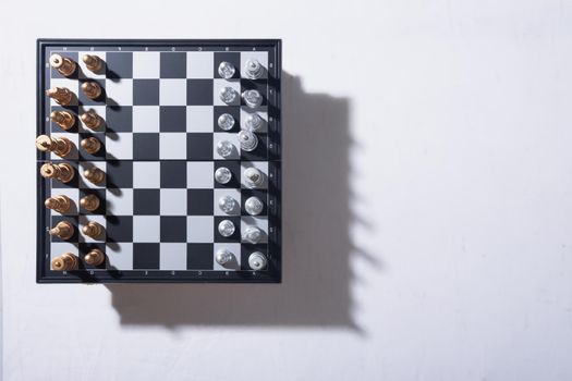 Chess pieces and chess board game concept with lighting and shadow