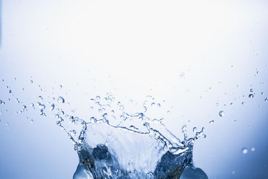 Water splash on blue abstract background